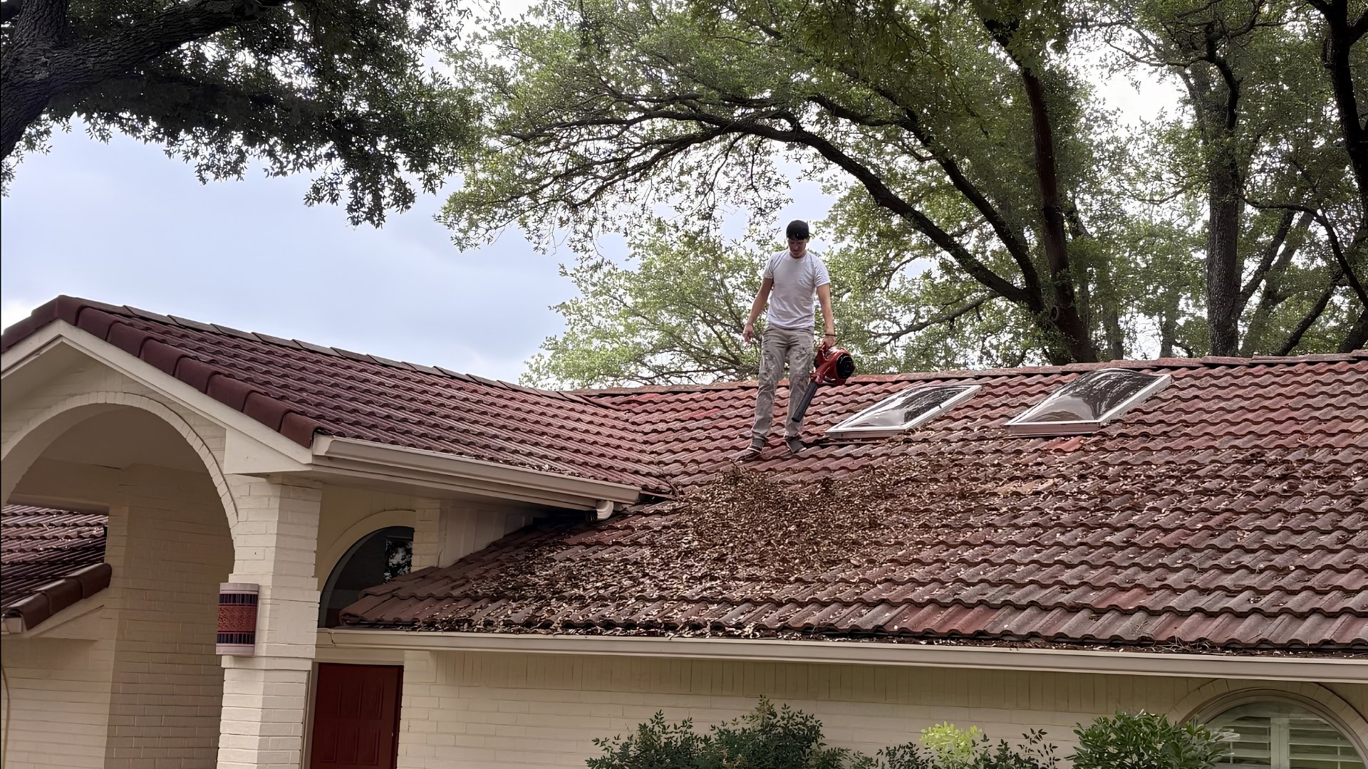 Leal's Legacy crew cleaning a tile roof in Marble Falls, TX